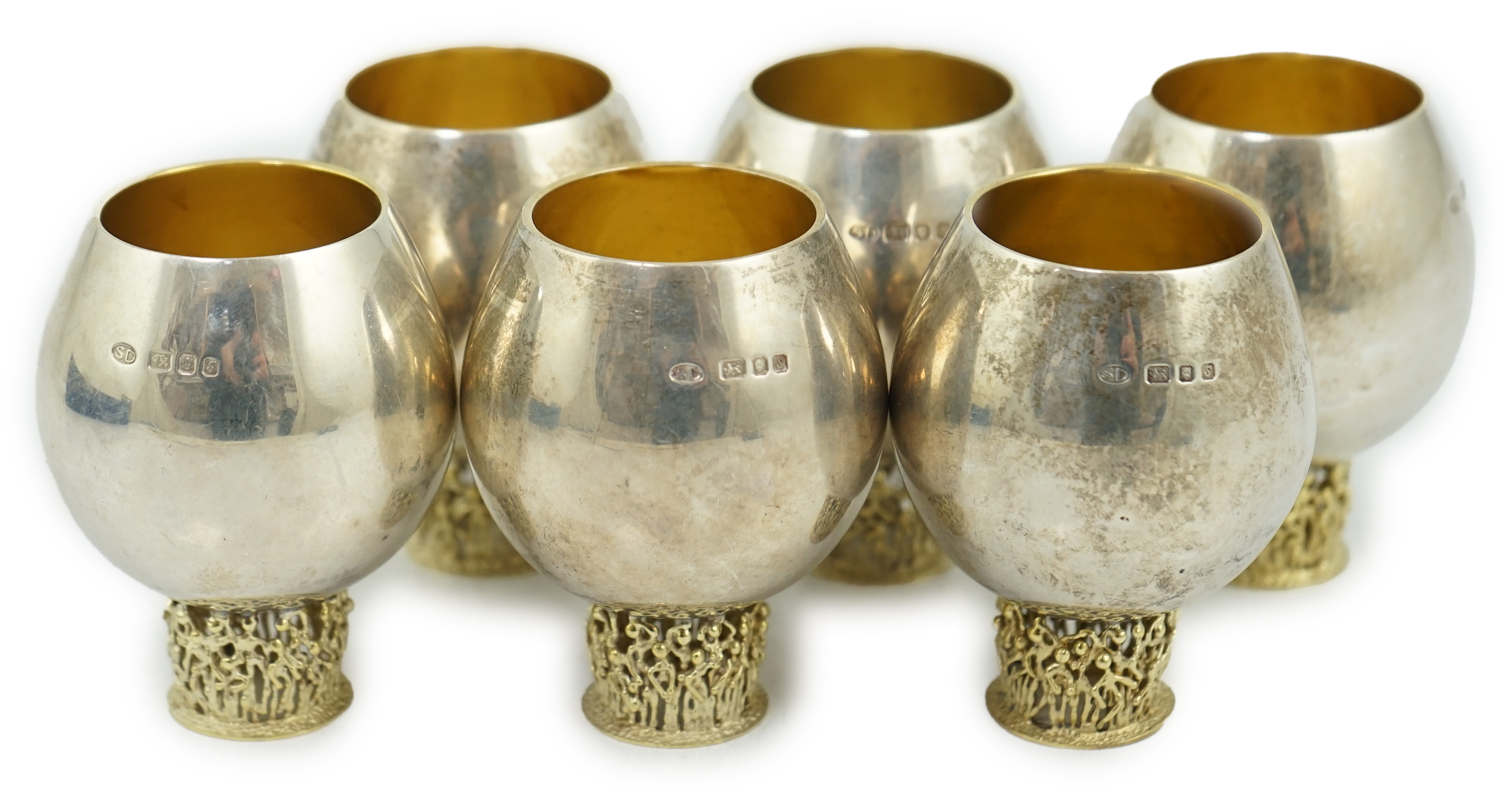 A set of six Elizabeth II Stuart Devlin parcel gilt silver balloon shaped pedestal tots